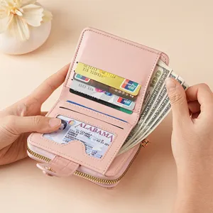 Elegant pink PU leather short wallet for women with card slots and zipper pocket.