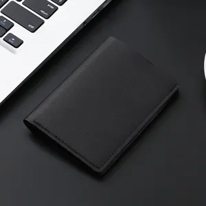Minimalist black leather card holder wallet for men and women, compact folding design.