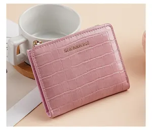 Dettaglio portafoglio corto rosa con trama coccodrillo e cursore zip dorato elegante.