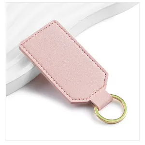 Minimalist pink PU leather keychain detail, blank square design with metal ring for custom logo.
