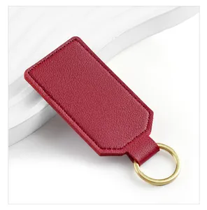 Red PU leather keychain detail closeup showing smooth texture and metal gold ring.