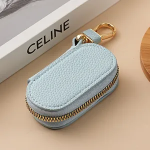 Estuche de llaves de cuero liso con patrón de lichi y cremallera dorada para coche y hogar.