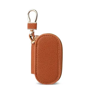 Estuche para llaves de cuero granulado liso con herrajes dorados, bolsa portátil para llaves.