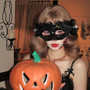 Close-up view of a Halloween black lace sequin eye mask worn by a model with a pumpkin.