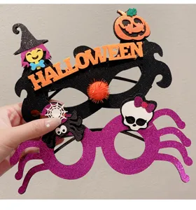 Close-up of festive Halloween party glasses featuring glitter spider and pumpkin motifs