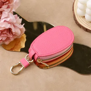 Mini car key case for men and women, stylish pink leather key pouch with golden keychain hook.