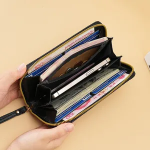 Women's long black zipper wallet clutch with multiple card slots and phone pocket.