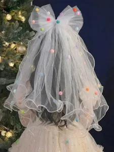 Back view of child's white mesh princess veil with bow and colorful pom-poms