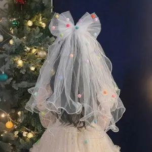 White tulle birthday veil for girls featuring a large bow and colorful pom-poms decor