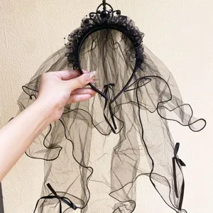 Close-up of black Halloween bridal veil headband with mesh bows and crown detail