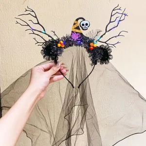 Detail of a glowing Halloween witch headband with black veil and skull decoration.