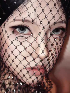 Close-up of a black fishnet face veil with sparkling rhinestones for music festivals