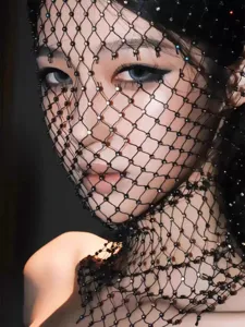 Detailed view of black fishnet face mask with sparkling rhinestones for festivals