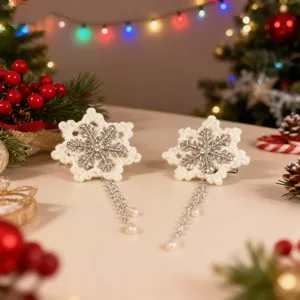 Close-up of white snowflake hair clips with sparkling rhinestone and pearl tassels
