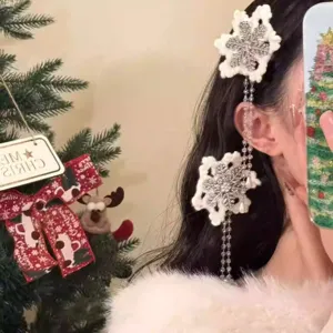 Close-up of the delicate snowflake hair clip with rhinestones and dangling tassels.