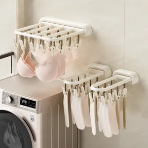 Opvouwbare wanddroogrek met meerdere knijpers voor sokken, ondergoed en kleine kleding.