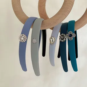 Detailed view of high-top sponge headbands with rhinestone accents in blue and gray tones.