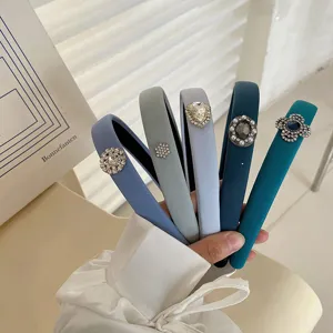 Detail of blue and grey fabric headbands with elegant rhinestone embellishments.