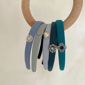 Close-up of elegant blue and gray sponge headbands with sparkling rhinestone decorations