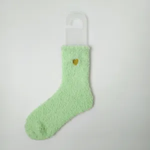 Detailansicht weiche korallenfleece Socken in Mintgrün mit goldener Herzstickerei