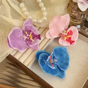 Realistic Phalaenopsis orchid floral hair clips in pink, blue, and purple for weddings