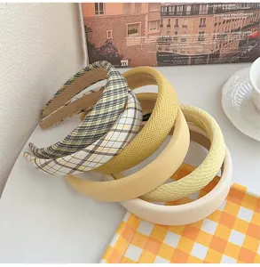 Collection of yellow and cream padded headbands with various fabric textures