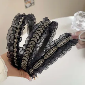 Elegant black ruffle headband with leaf-shaped rhinestones and diamond patterns.