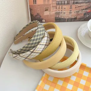 Set of stylish yellow fabric headbands featuring plaid and textured designs for women