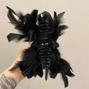 Close-up detail view of an elegant black ostrich feather hair claw clip for women