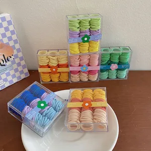 Juego de mini gomas para el pelo de colores arcoíris en cajas de almacenamiento claras