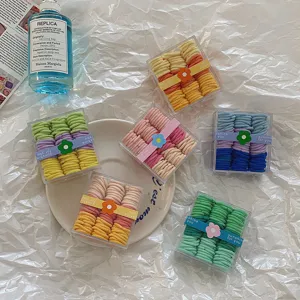 Set de mini gomas de pelo coloridas en cajas transparentes con detalles florales