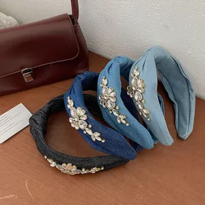 Detailed view of denim headbands with intricate floral rhinestone accents
