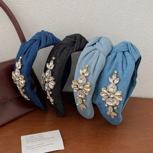 Detailed view of luxury denim knotted headbands with sparkling rhinestone embellishments