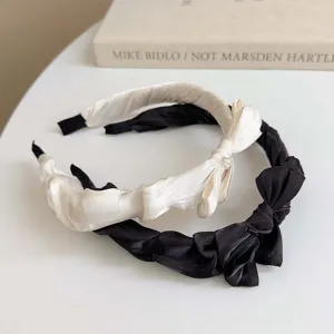 Elegant black and white pleated satin headbands featuring sweet bow designs for women
