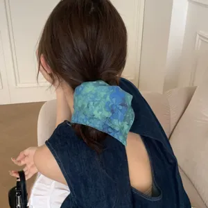 Elegant French style blue floral hair scrunchie scarf tied on model ponytail back view.