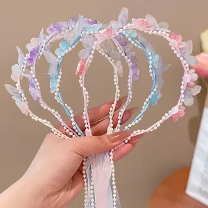 Close-up of fairy-style butterfly headbands with pearls and ribbons for girls