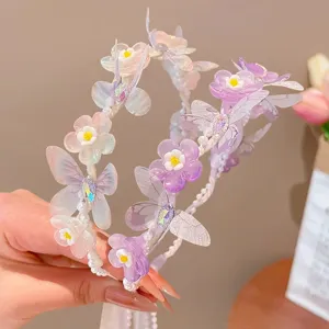 Detailed view of fairy-style girls butterfly flower headband with pearl ribbons