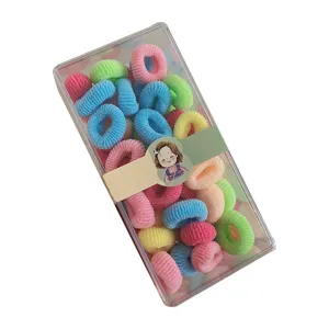 Pack of colorful mini elastic hair ties for toddlers in a transparent gift box.