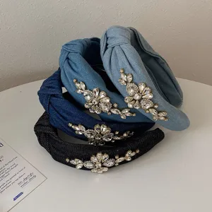 High-resolution close-up of stacked denim headbands with intricate floral rhinestone details.