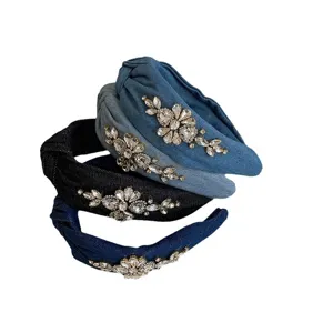 Elegant denim knotted headbands with luxury rhinestone floral embellishments.