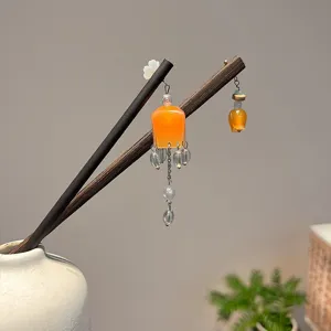 Elegant Chinese style wooden hairpins with orange lantern pendants and delicate tassels.