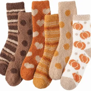 Cozy coral fleece mid-tube socks with various warm-toned patterns for home wear