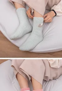 Detailed texture of warm mid-calf coral fleece fuzzy socks for women in green and pink