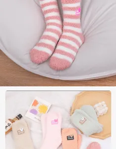 Close-up of soft winter fuzzy coral fleece socks in various warm colors