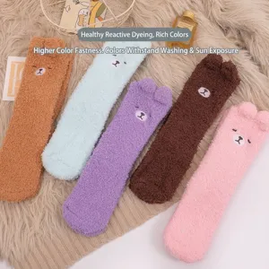 Set of colorful fuzzy coral fleece socks with cute cartoon bear ears and embroidery.