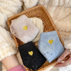 Drei Paar warme Korallenfleece-Socken mit Herzbestickung und rutschfester Sohle.