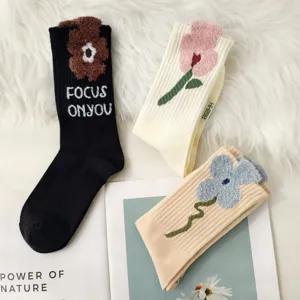 Close-up of three pairs of vintage floral knit crew socks for winter