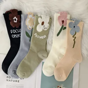 Cozy winter mid-calf socks for women featuring colorful 3D fuzzy flower designs