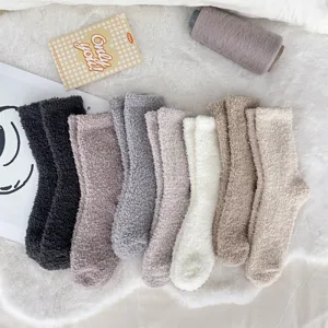 Close-up of cozy multi-color coral fleece sleep socks showing soft fluffy texture for home