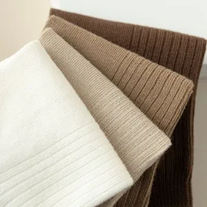 Close-up of ribbed knit texture for men's cotton boat socks in various earthy colors